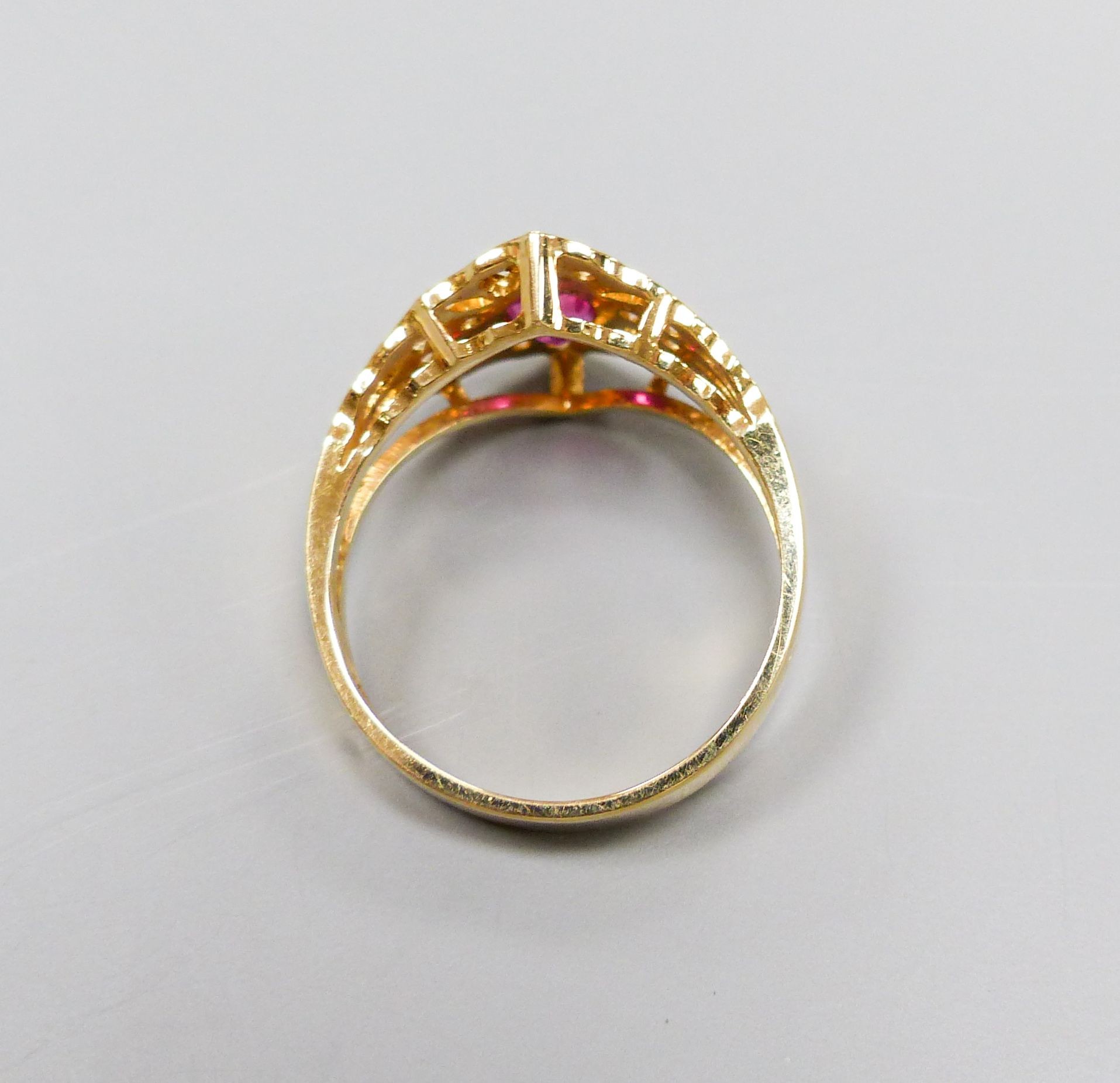 A modern 14ct gold, single stone ruby and diamond chip cluster set dress ring, size O, gross 4.1 grams.